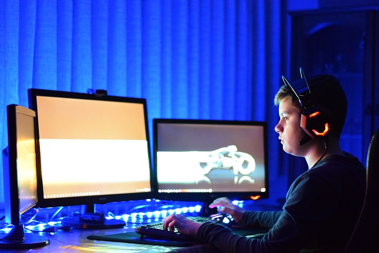 Teen playing online game on his PC